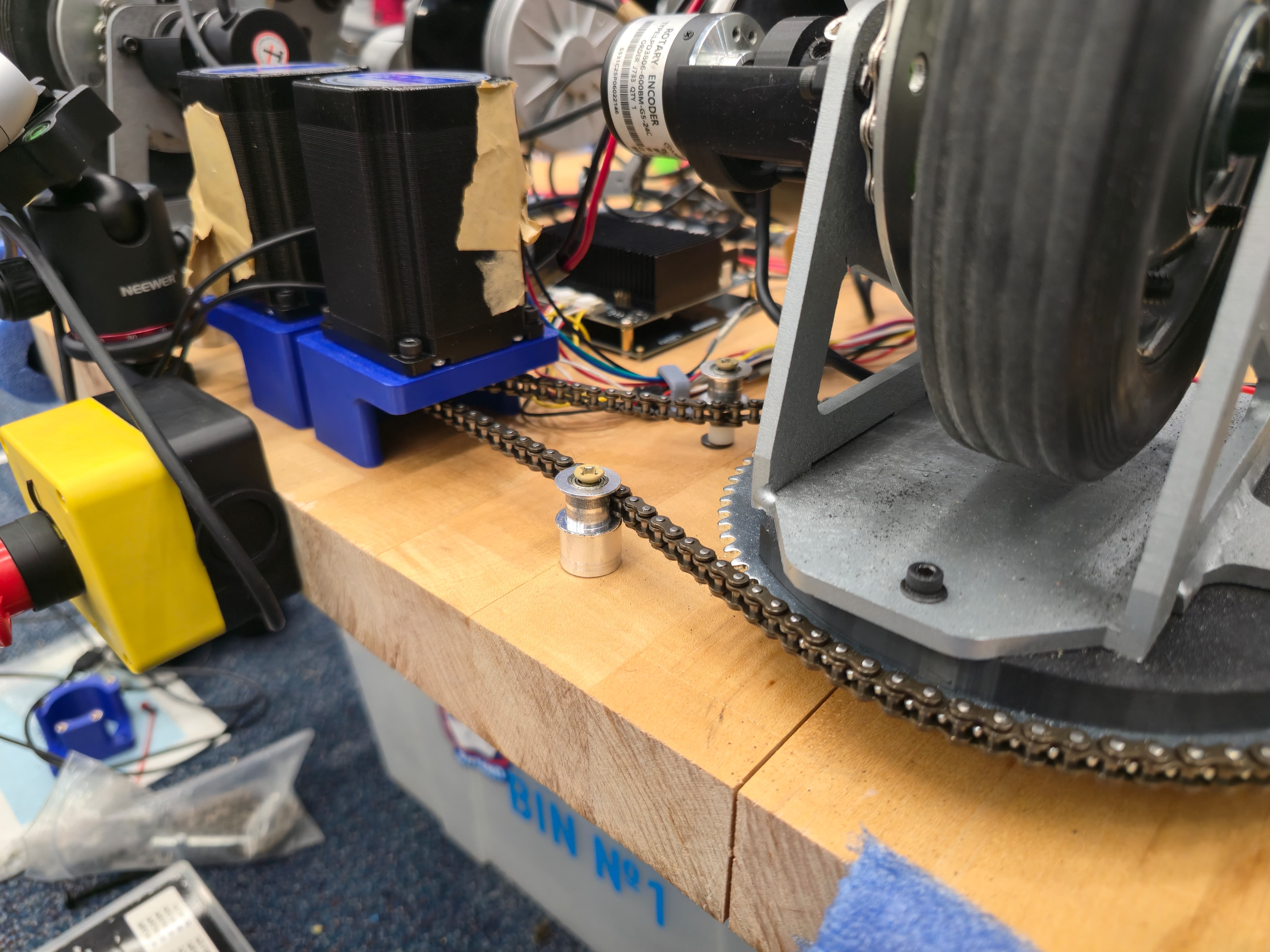 Steering system with chain tensioner and sprockets